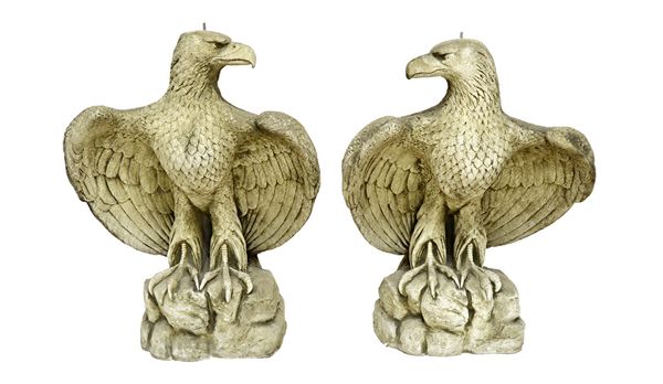 A pair of 20th century reconstituted stone figures of basking eagles, 65cm wide x 85cm high (2). Illustrated