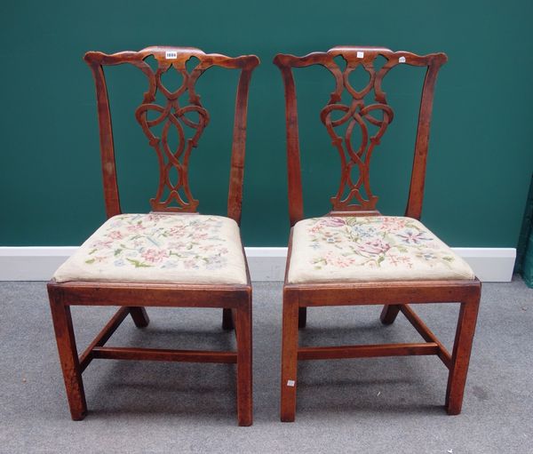 A pair of mid 18th century mahogany framed dining chairs, with interlaced splat and straight front seat on canted square supports, (2).