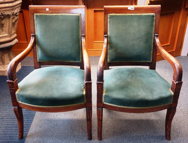 A pair of early 19th century French mahogany framed open armchairs, with bow seats, and sabre supports, (2).