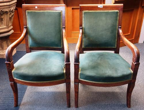A pair of early 19th century French mahogany framed open armchairs, with bow seats, and sabre supports, (2).