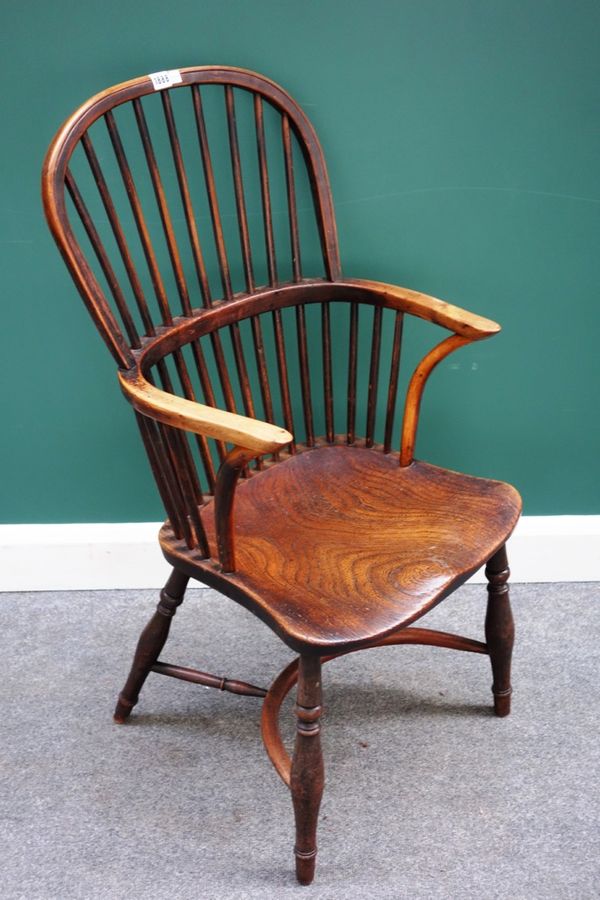 A George III yew and elm stick back Windsor chair, on turned supports, united by a crinoline stretcher.