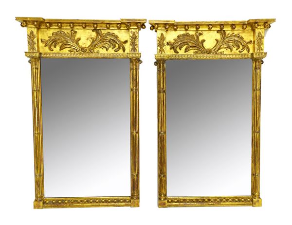 A pair of Regency pier glasses, each with ball mounted inverted crest, above floral scrolling upper frieze and rectangular mirror plate, flanked by sp