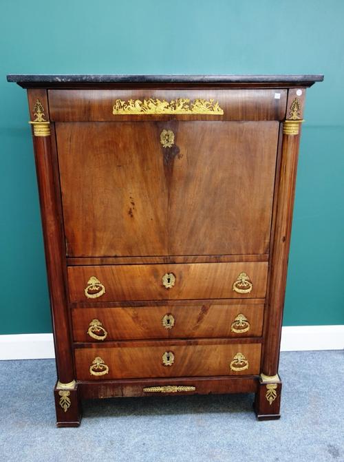 A French Empire secretaire a abattant, the marble top on a gilt metal mounted mahogany base with one long drawer over fall front and three further lon