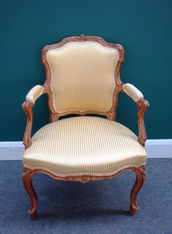 An 18th century French gilt framed open arm fauteuil, with serpentine seat on cabriole supports.