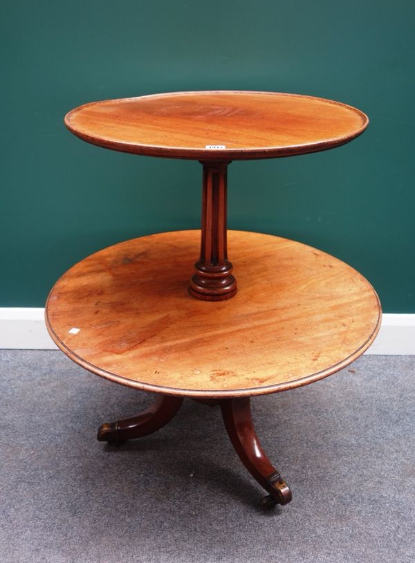 An early 19th century mahogany graduated circular two tier dumb waiter on a tripod base, 77cm wide.