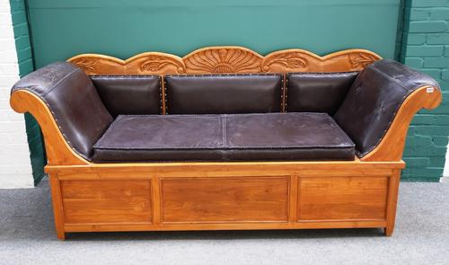 A Biedermeier design walnut framed sofa, with carved crest rail and roll over arms, the lower frieze with flush fit drawer, 224cm wide.