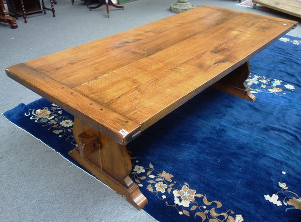 A 17th century style oak refectory table, the cleated plank top on a pair of trestle end standards, 93cm wide x 213cm long.