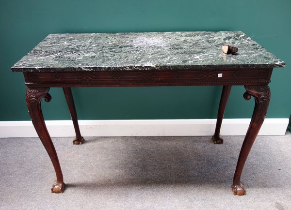 A George III style mahogany side table, the rectangular marble top over a fret cut blind frieze, on cabriole supports and ball and claw feet, 115cm wi