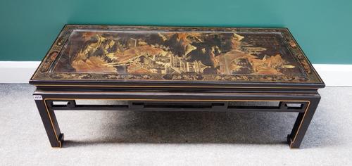An early 20th century Chinese black lacquer chinoiserie decorated rectangular coffee table, with pierced frieze on block supports, 114cm wide.