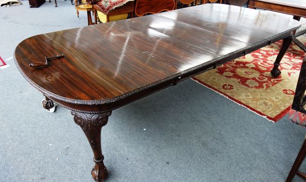 An early 20th century mahogany extending dining table, the rounded rectangular top on four acanthus cabriole supports, on claw and ball feet, to inclu