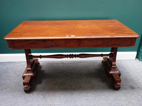 A William IV mahogany writing table, the rounded rectangular top with pair of flush fit frieze drawers on a pair of trestle end standards and four scr