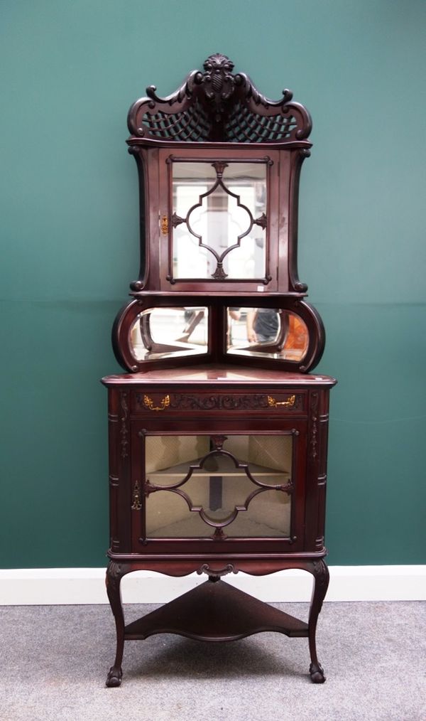 A late 19th century mahogany double height corner display cupboard, the pierced lattice top over a pair of astragal glazed cupboards divided by single