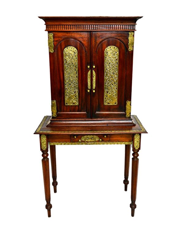 A 19th century brass mounted Eastern hardwood side cabinet, the pair of arch top cupboard doors over single frieze drawer, on tapering octagonal suppo