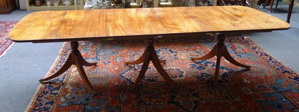A Regency style mahogany triple pillar dining table, on twelve downswept supports, 107cm wide x 303cm long.