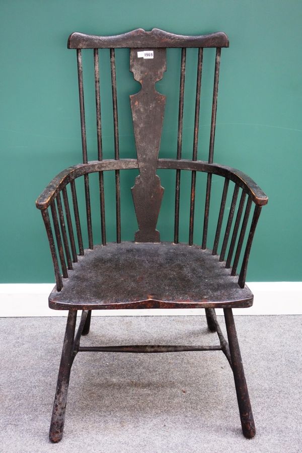 A George III style black painted comb back Windsor chair, with solid seat and turned supports.