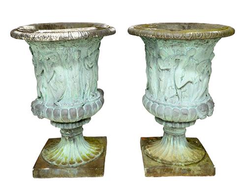 A pair of reconstituted stone jardinieres, relief moulded with dancing figures over fluted body and socle on square base, 89cm high. (2)  Illustrated