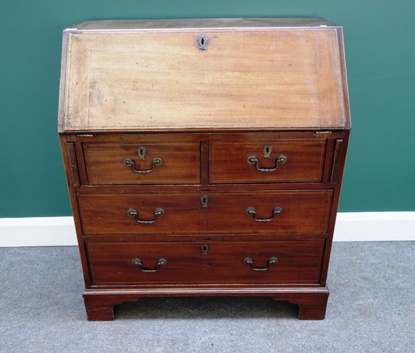 A George III mahogany bureau, the fall enclosing a fitted interior, over two short and two long drawers, on bracket feet, 84cm wide.