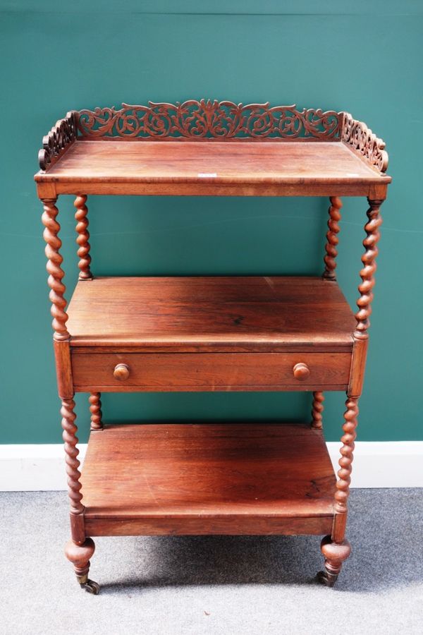 A Victorian rosewood what-not, the pierced fret carved galleried upper tier over two further tiers, one with drawer, on barleytwist supports, 65cm wid