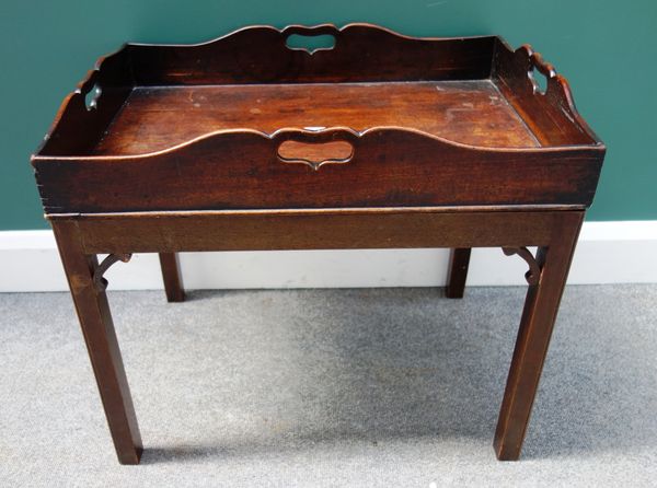 A George III mahogany rectangular butler's tray, with pierced sides, on a later stand, 64cm wide.