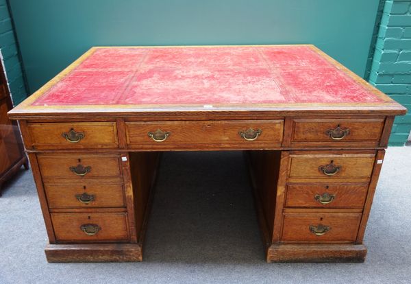 A Victorian oak partner's pedestal desk, with nine drawers about the knee, with matching verso, on a plinth base, 153m wide.