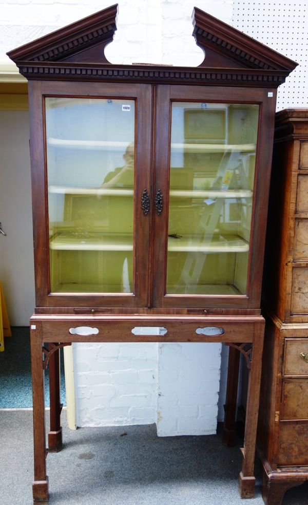 A George III and later display cabinet on stand, the broken architectural cornice, over a pair of glazed doors, the stand with pierced frieze, on cant