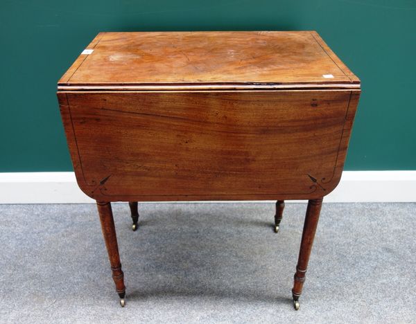 An early 19th century mahogany drop flap work table, with pair of frieze drawers and dummy opposing, on tapering turned supports, 61cm wide.