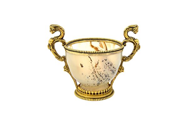 A 19th century French agate and silver gilt twin handled cup, the handle terminals formed as classical female masks, the rims with beaded decoration,