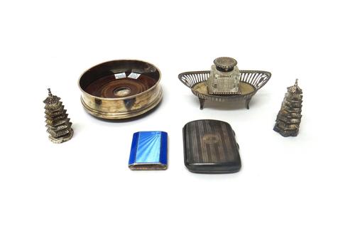 A Victorian silver inkwell, of navette form, with pierced decoration, Chester 1898, a circular silver mounted bottle coaster by Carrs, a pair of Japan