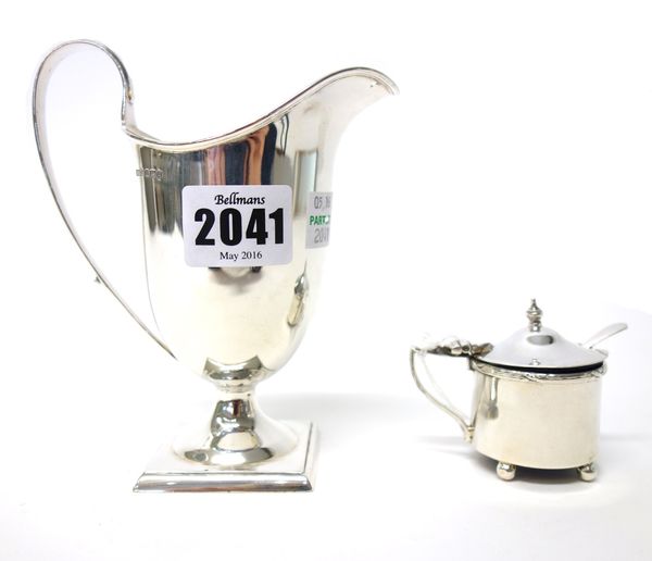 A silver helmet shaped milk jug, raised on a square foot, Sheffield 1908 and a silver circular mustard pot, Birmingham 1911, combined weight 174 gms,