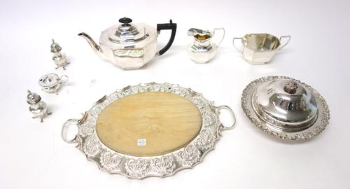 A pair of Victorian silver pepperettes, each raised on four feet, Birmingham 1898 and plated wares, comprising; a three piece tea set, a lidded muffin