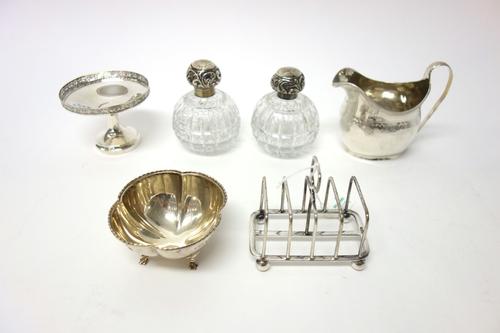 Silver and silver mounted wares, comprising; a George III helmet shaped milk jug, with engraved decoration, London 1809, a five bar toastrack, raised