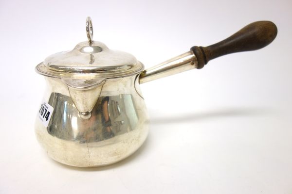 A George III silver brandy saucepan and cover, of baluster form, fitted with a later turned wooden handle, the detachable cover with a loop shaped han