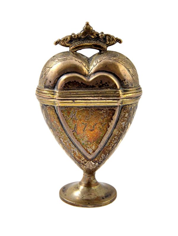 A silver heart shaped hinge lidded cachou box, with a crown finial to the lid and on an oval foot, the body initial engraved and detailed 1753, possib