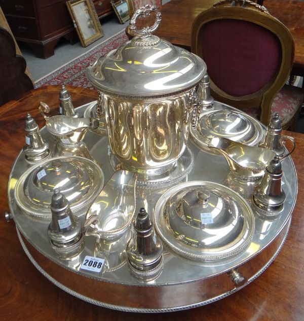 A silver plated lazy Susan, of circular rotating form, the centre with an associated lidded soup tureen with lion mask and ring handles, surrounded by