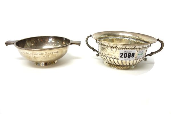 Silver, comprising; a twin handled bowl of circular form and with semi spiral fluted decoration, raised on a circular foot, diameter 13cm, Birmingham