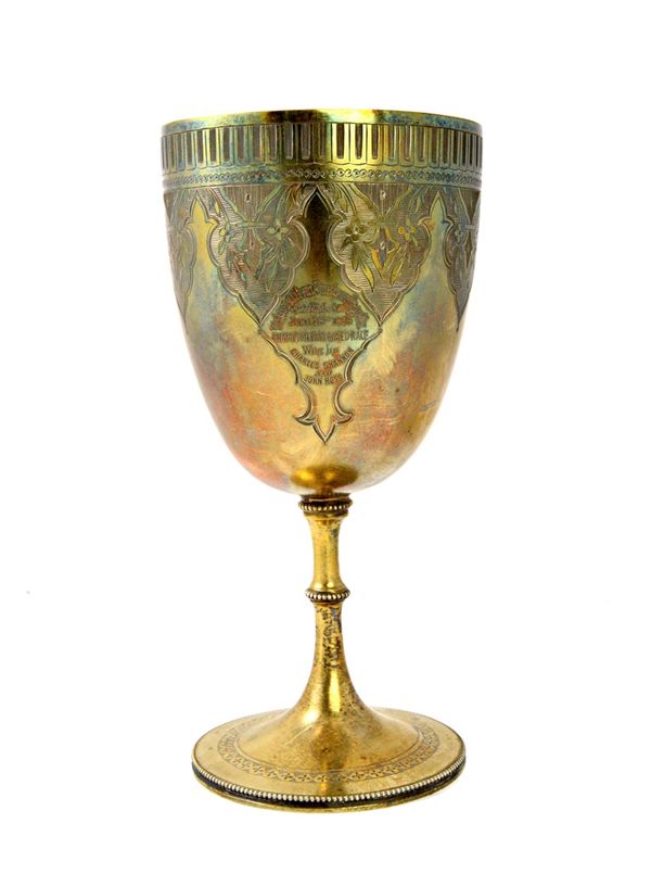 A Victorian silver trophy goblet, presentation inscribed beneath an engraved border, raised on a circular foot, decorated with a beaded rim, London 18