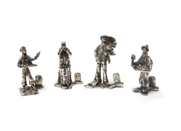 A group of four place name or menu stands, modelled as individual figures in Victorian costume, including a chimney sweep and street vendors.