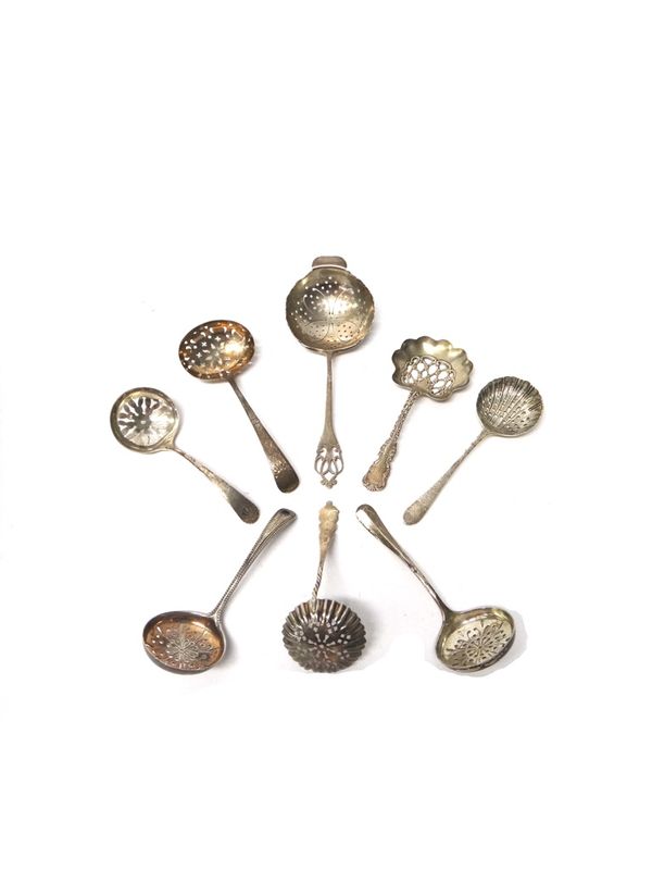 A silver tea strainer, the handle with pierced decoration, Sheffield 1929, six silver sugar sifting spoons and a sterling sugar sifting spoon, various