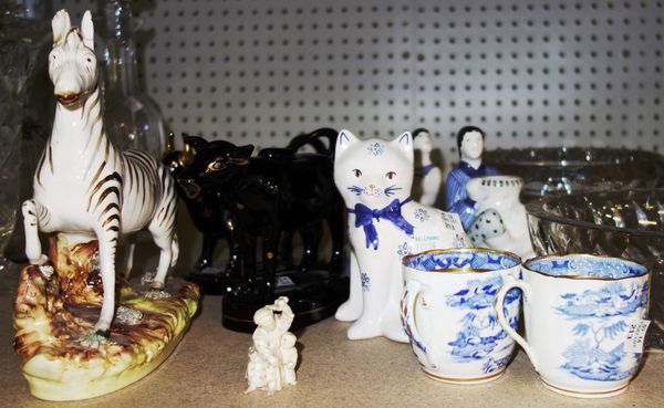 A quantity of ceramics, including; a pair of Rye pottery candlesticks, black cow creamers, a Staffordshire style zebra and sundry. (qty)