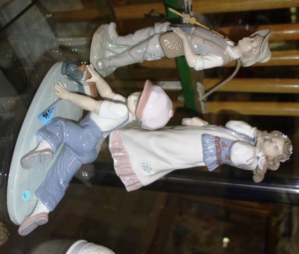 A group of three Lladro figures 'Dress of a summer past', 'Pescador' and 'All aboard'. (3)
