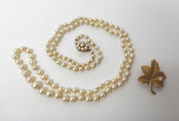 A single row necklace of graduated cultured pearls, on a 9ct gold and cultured pearl set cluster clasp and a gold and cultured pearl brooch, designed