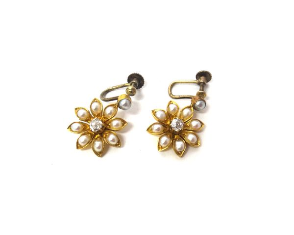 A pair of gold, diamond and half pearl set earrings, the drops designed as flowerheads, each centred by a cushion shaped diamond, within a surround of