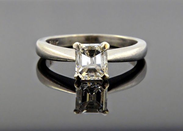 A platinum and diamond set single stone ring, by David Morris, claw set with an emerald cut diamond, ring size M and a half, with an Anchor Cert diamo