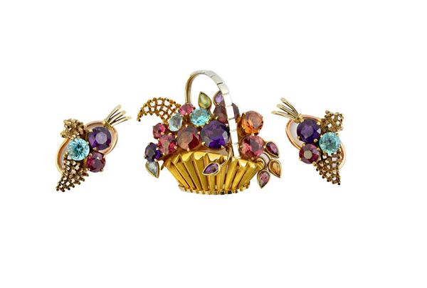 A gold and vary coloured gemstone set brooch, designed as a basket of flowers, the variously cut gemstones including; zircon, amethyst and garnet, det