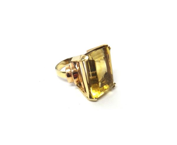 A gold ring, claw set with a rectangular cut citrine, between curved stepped shoulders, detailed 9 CT OBLO, ring size O, with a case.