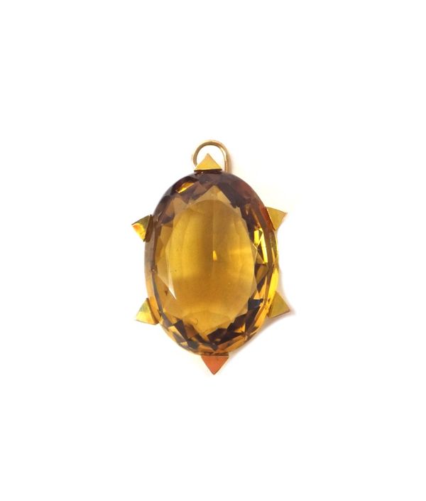 A 15ct gold pendant in a stylised star design, centred with an oval cut citrine, length (excluding suspension loop) 3.1cm, gross weight 10.1gms.