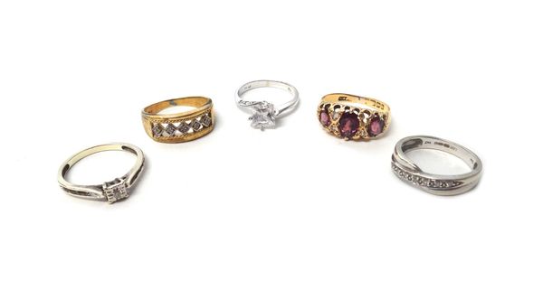 An 18ct gold ring, mounted with three oval cut garnets, Birmingham 1909, a gold and diamond set ring, detailed 9 CT, a 9ct white gold and diamond set