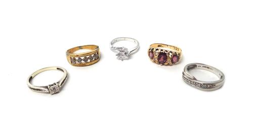 An 18ct gold ring, mounted with three oval cut garnets, Birmingham 1909, a gold and diamond set ring, detailed 9 CT, a 9ct white gold and diamond set