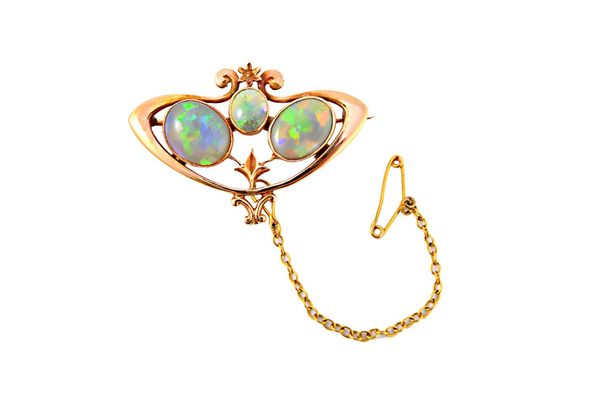 A gold brooch, mounted with three oval opals, pierced in a scrolling design, fitted with a safety chain, with a case.  Illustrated