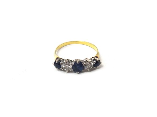 A gold, sapphire and diamond set five stone ring, claw set with three cushion shaped sapphires, alternating with two circular cut diamonds, ring size